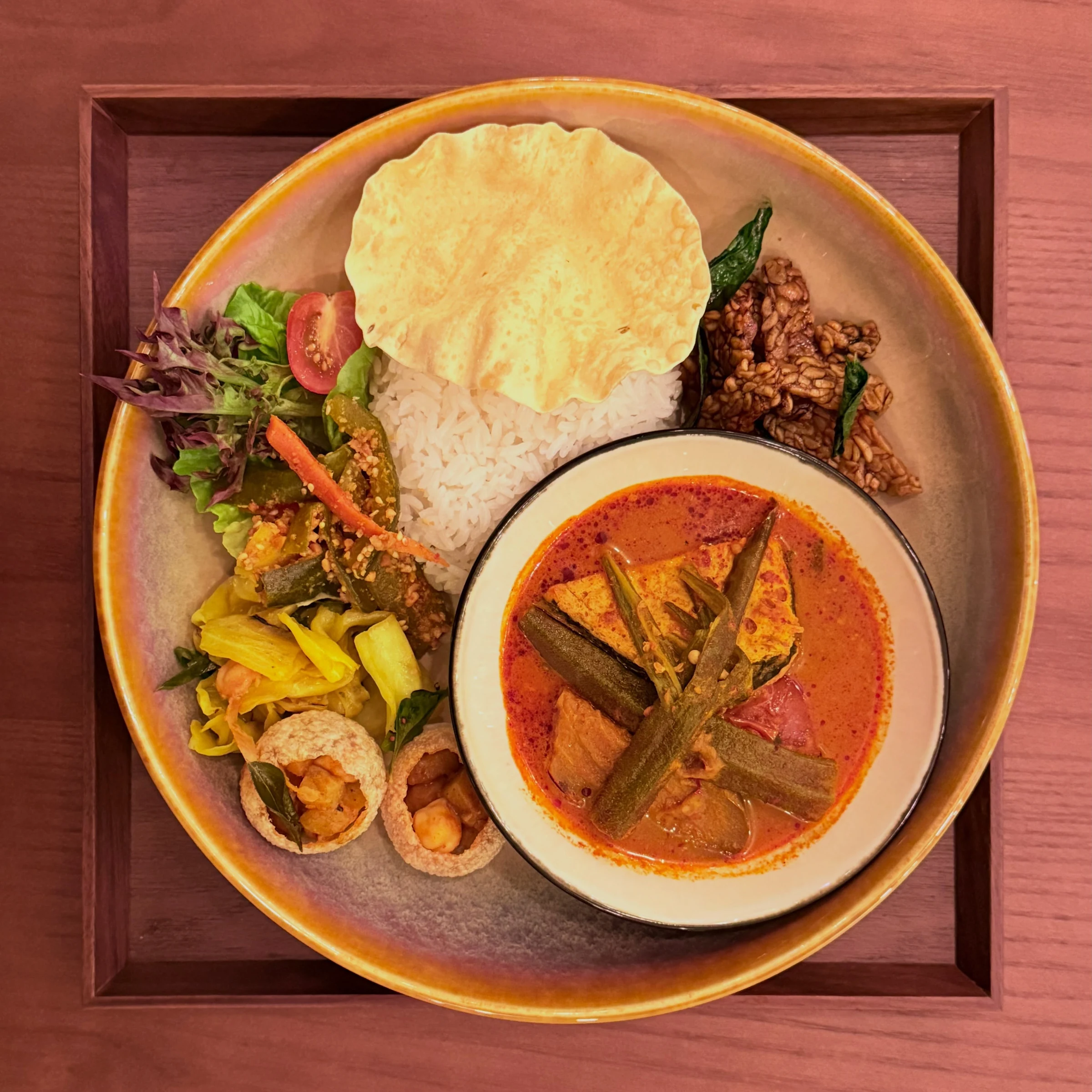 Peranakan-inspired curry set with rice, tempeh and vegetable sides