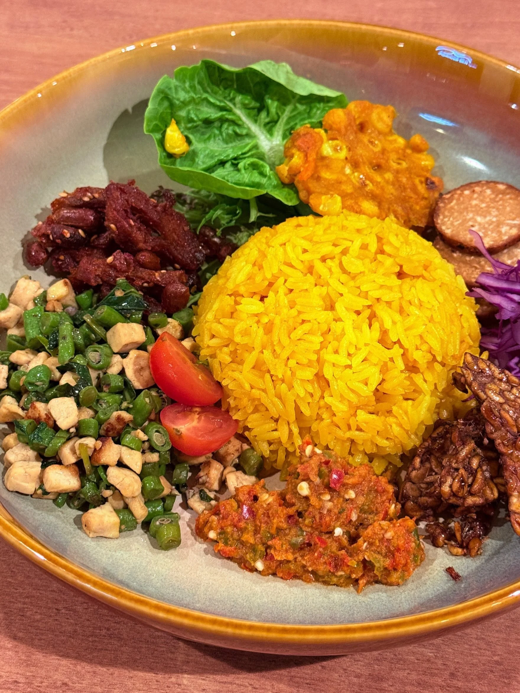 Turmeric rice bowl with tofu, tempeh, sambal and vegetables